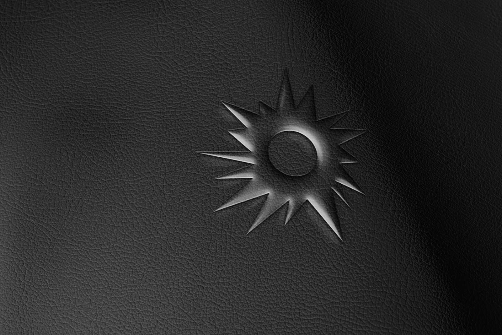 RIOT monogram embossed on black leather